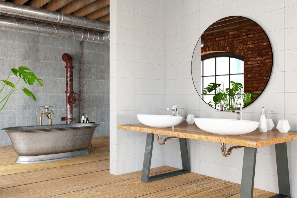 Bancada de madeira com pés em aço. Faz parte da decoração de um banheiro industrial. Imagem disponível em Getty Images.