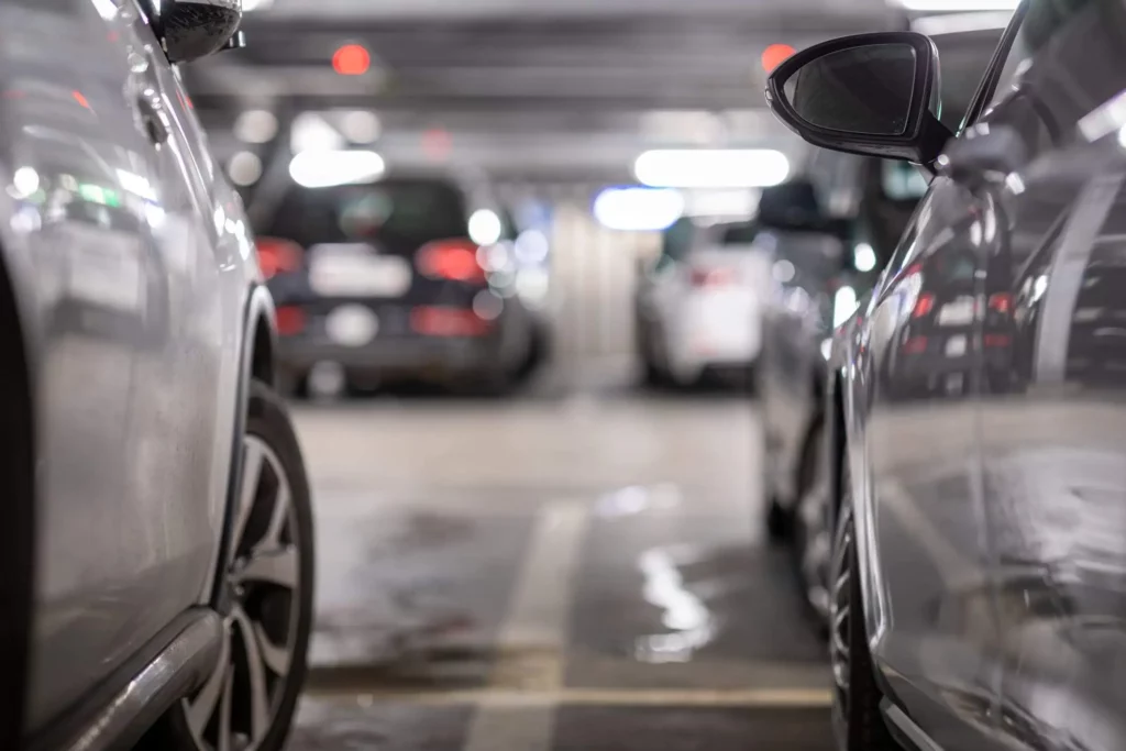 Imagem da lateral de dois carros estacionados em um condomínio para ilustrar matéria sobre garagem de condomínio é área comum