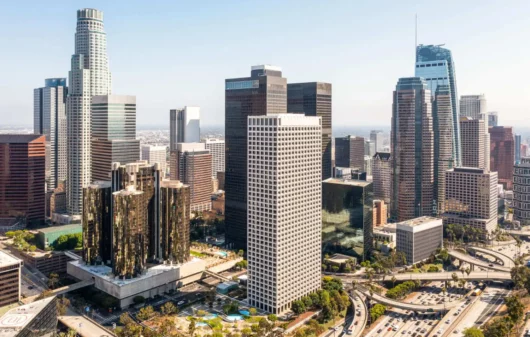 Imagem aérea do centro urbano de uma cidade mostra prédios, avenidas e vegetação para ilustrar matéria sobre as vantagens de morar no centro