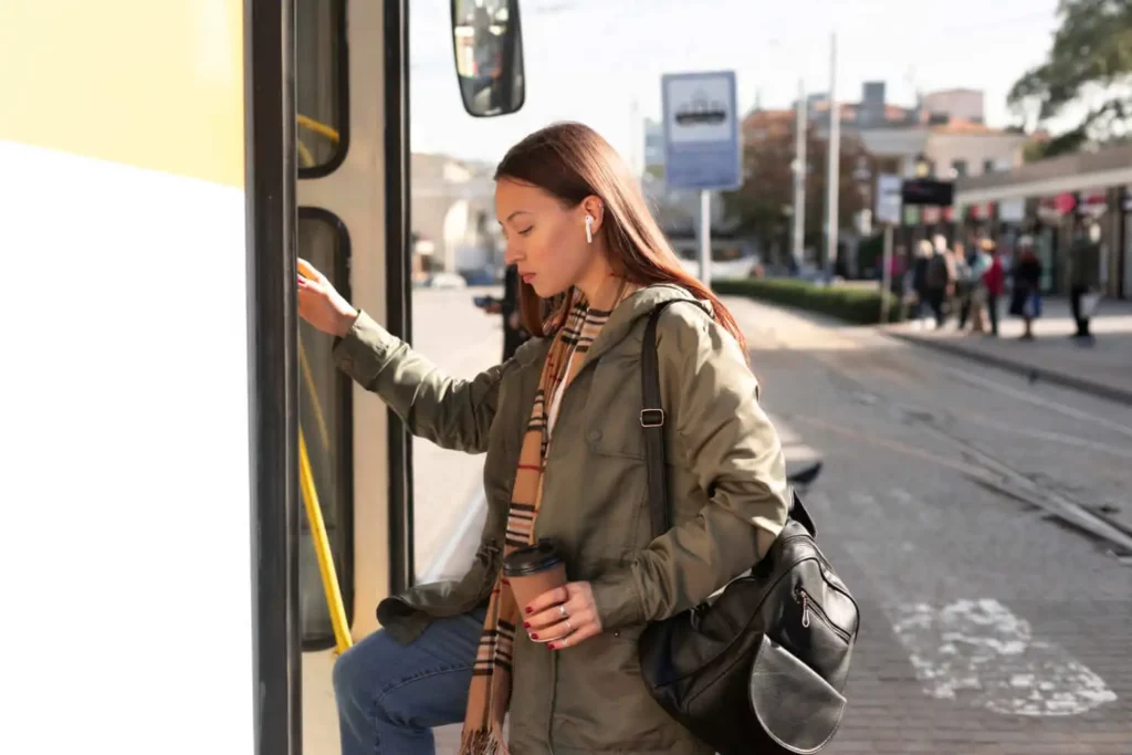 Imagem de uma mulher bem agasalhada entrando em ônibus para ilustrar matéria sobre as vantagens e desvantagens de morar no centro